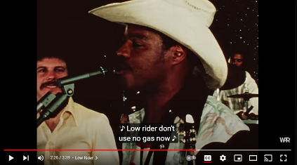 guy from the band war gazing lovingly at the singer